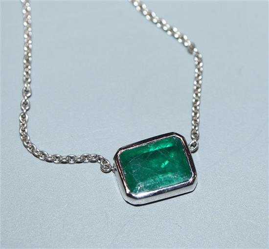 An 18ct white gold and solitaire emerald set pendant necklace, pendant 9mm.